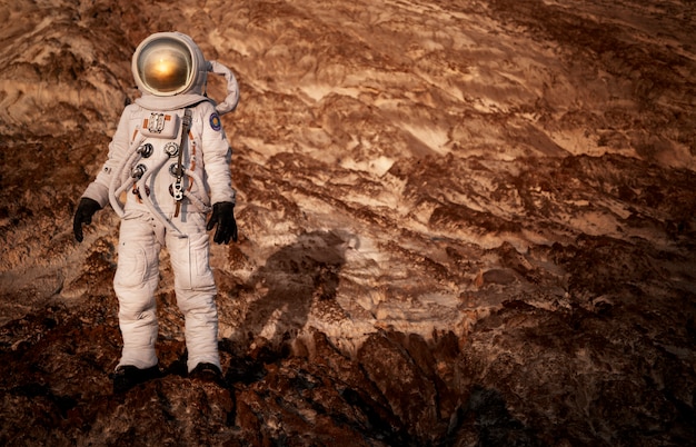 Male astronaut exploring the surroundings during a space mission on another planet