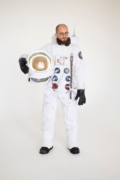 Free photo male astronaut holding his helmet