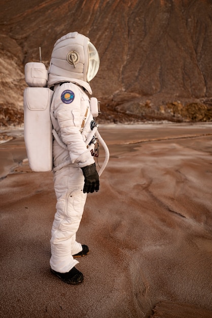 Male astronaut looking around during a space mission on another planet