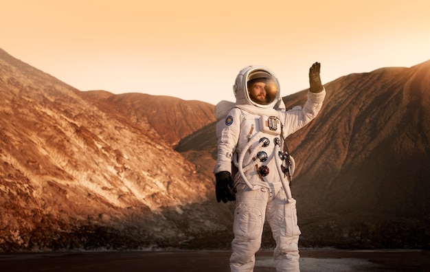 Free photo male astronaut protecting his eyes from the sun during a space mission on another planet