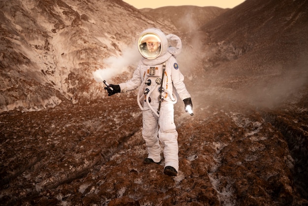 Free Photo male astronaut signaling his location during a space mission on an unknown planet