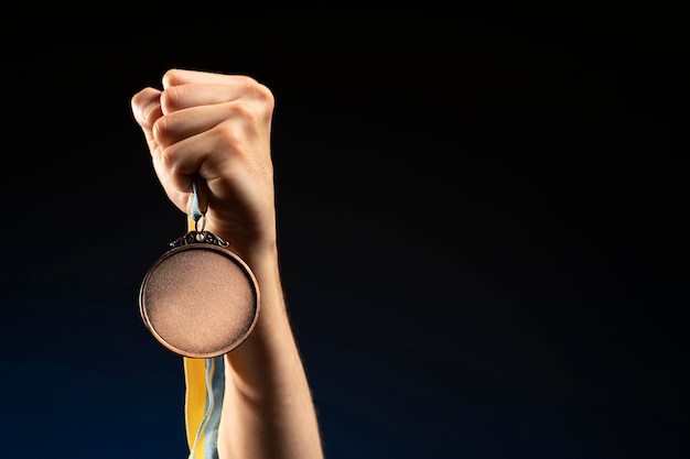 Male athlete holding a gold medal