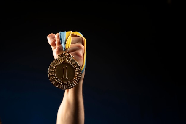 Free Photo male athlete holding a medal