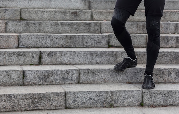 Free Photo male athletic legs walking on stairs