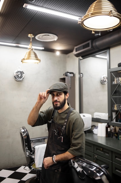 Free photo male barber sitting at his shop