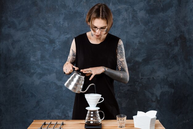 Male barista brewing coffee. Alternative method pour over.