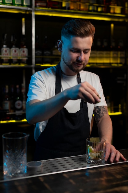 Free Photo male bartender making a delicious cocktail