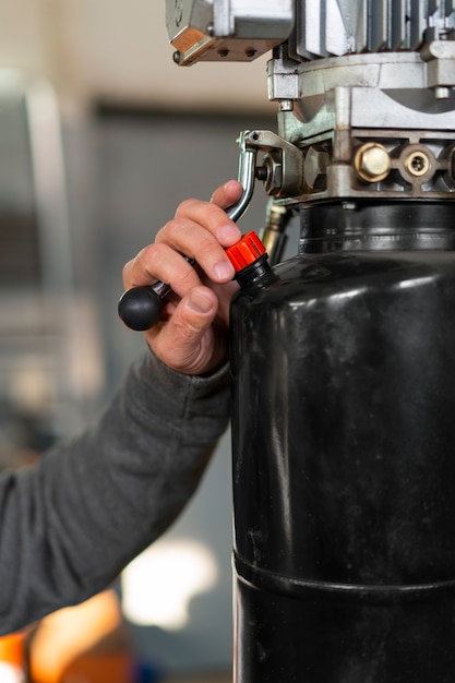 Free photo male car mechanic working in the car repair shop