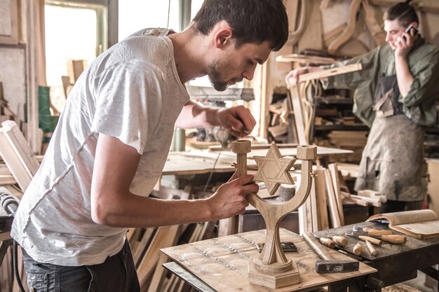 Free Photo male carpenter working with a wood product, hand tools