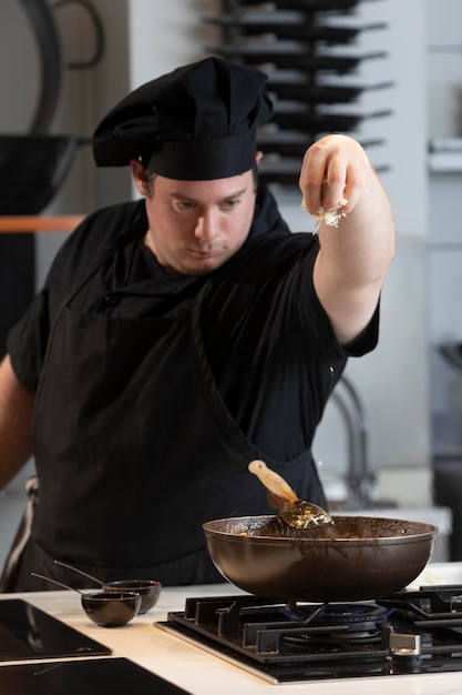 Male chef in kitchen cooking