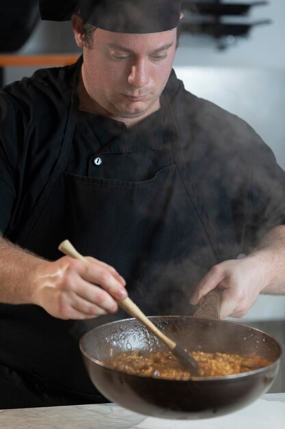 Male chef in kitchen cooking