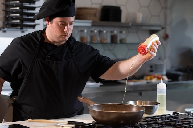 Free photo male chef in kitchen cooking