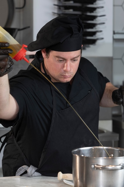 Free photo male chef in kitchen cooking