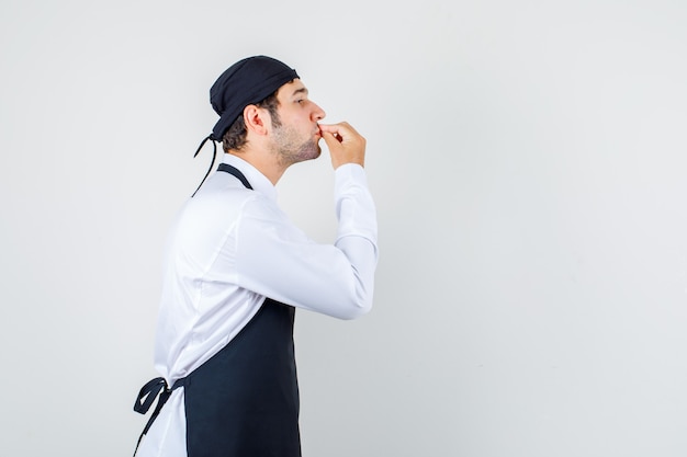 Male chef making delicious gesture in uniform, apron .