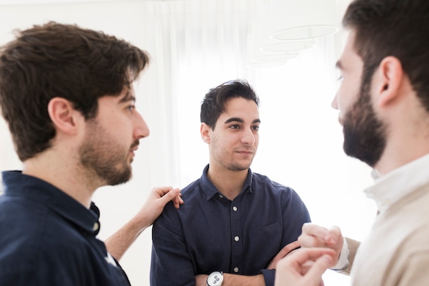 Free Photo male colleagues talking in office