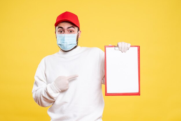 male courier in mask holding file note on yellow