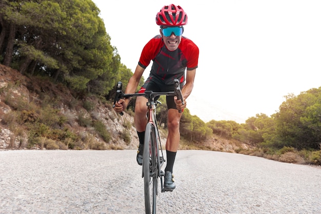 Male cyclist training with bicycle outdoors