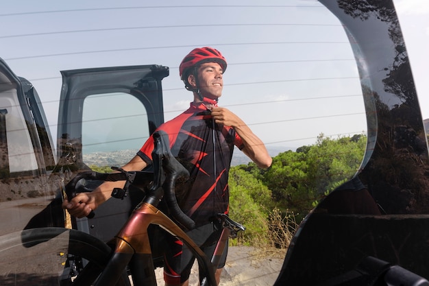 Free photo male cyclist with bike and helmet outdoors in nature