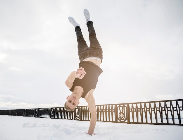 Free Photo male dancer standing in one hand