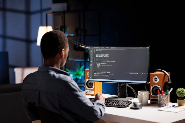 Free Photo male developer entering binary data on terminal panel