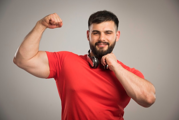 Free Photo male dj in red shirt with headphones in the neck. 