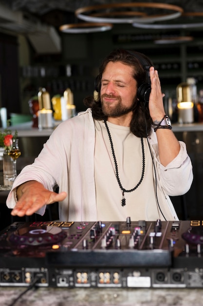 Male dj taking care of the music entertainment at a party