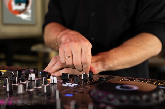 Male dj taking care of the music entertainment at a party