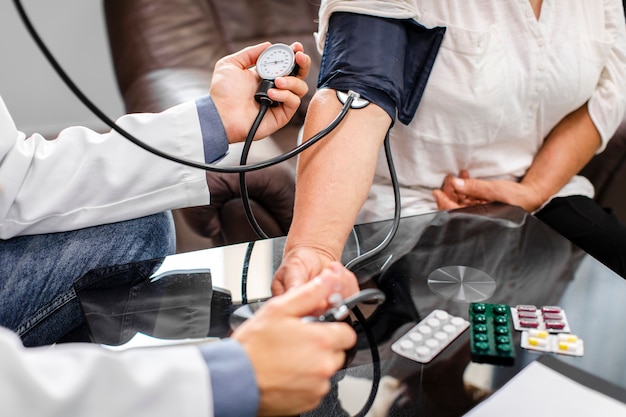 Free Photo male doctor hands measuring tension to a patient