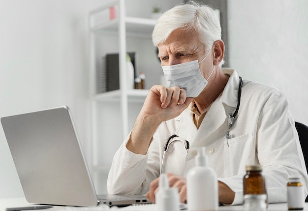 Male doctor at his desk with some medicine