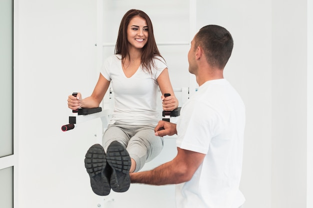 Male doctor lifting patient legs