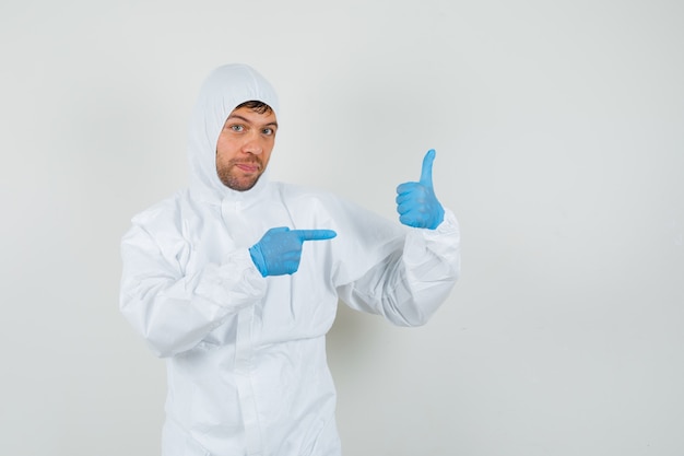 Free photo male doctor pointing at his thumb up in protective suit