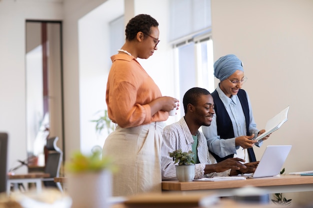 Male employee getting used to his new office job along with female colleagues