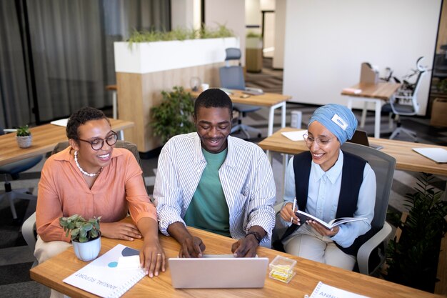 Male employee getting used to his new office job along with female colleagues