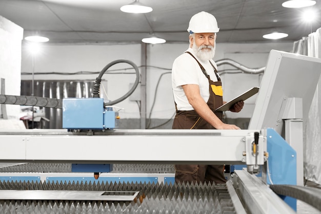 Free Photo male engineer looking at camera while working with computer