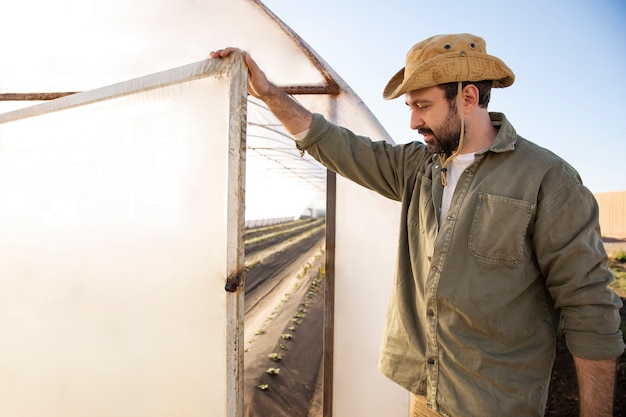 Male farmer in the greenhouse at his farm