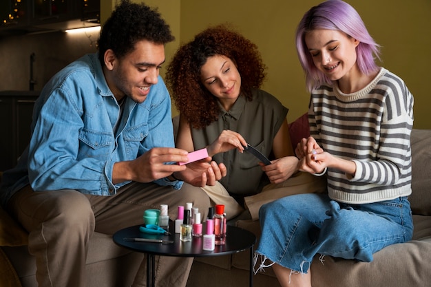 Free photo male and female friends getting a manicure together