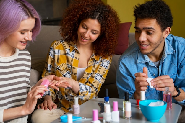 Free photo male and female friends getting a manicure together