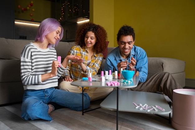 Free photo male and female friends getting a manicure together