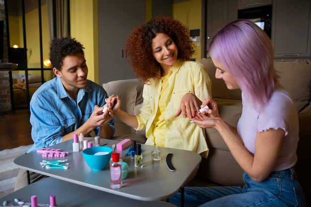 Free photo male and female friends getting a manicure together