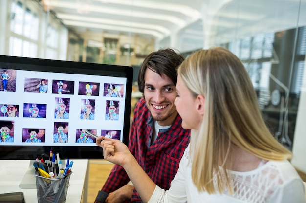 Free photo male and female graphic designers interacting over computer