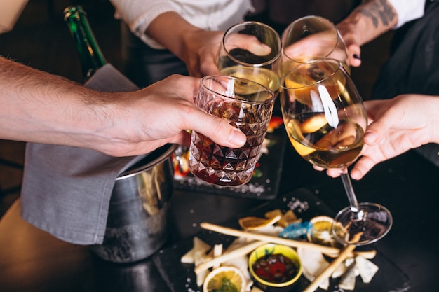 Male and female hands close up with cocktails