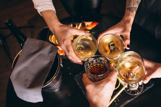 Male and female hands close up with cocktails