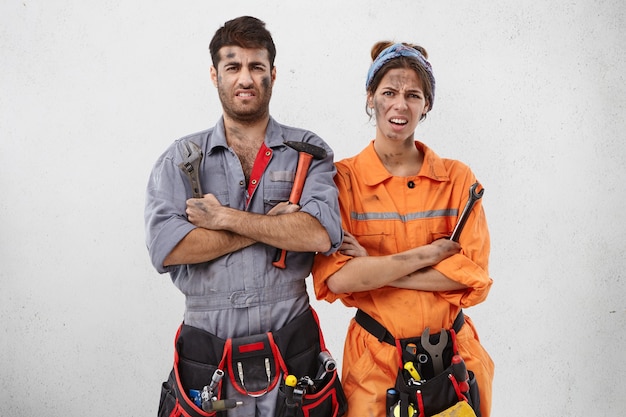 Male and female workers wearing work clothes