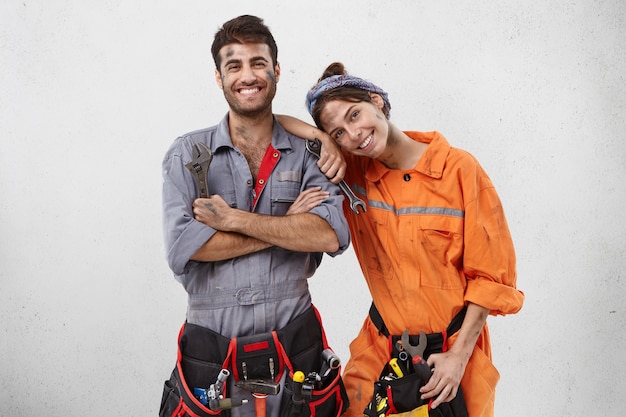 Male and female workers wearing work clothes