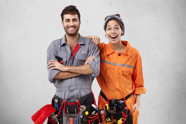 Male and female workers wearing work clothes