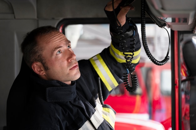 Free Photo male firefighter at the station inside fire truck