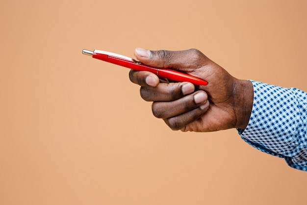 Male hand holding pencil, isolated