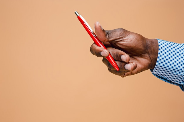 Male hand holding pencil, isolated