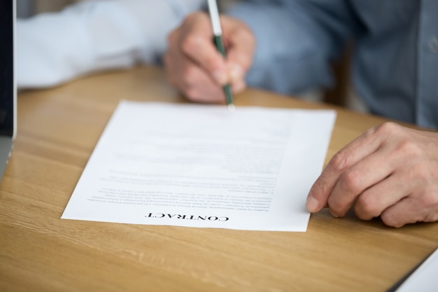 Male hand signing contract, senior man putting signature on document