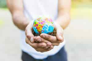 Free photo male hands holding small globe